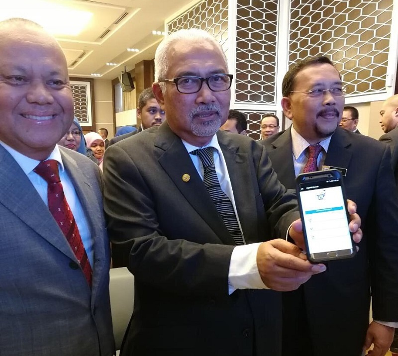 The Malay Mail Tan Sri Mohd Hashim Abdullah displaying the mobile application.